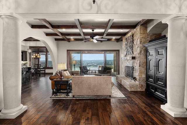 908 Watercliffe Dr, Lago Vista, TX 78645 - living room with ornate columns, a ceiling fan, beamed ceiling, dark wood finished floors, and arched walkways