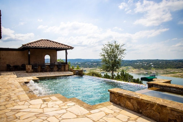 908 Watercliffe Dr, Lago Vista, TX 78645 - view of swimming pool featuring area for grilling, a patio area, a water view, and an infinity pool
