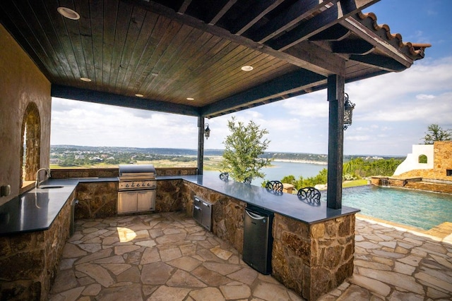 908 Watercliffe Dr, Lago Vista, TX 78645 - view of patio / terrace featuring an outdoor kitchen and a water view