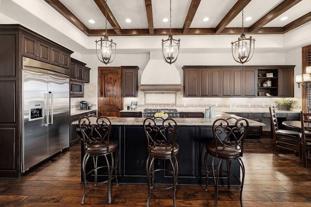 908 Watercliffe Dr, Lago Vista, TX 78645 - kitchen featuring built in appliances, custom exhaust hood, dark wood-type flooring, beamed ceiling, and dark brown cabinetry