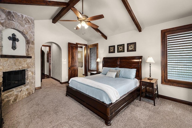 908 Watercliffe Dr, Lago Vista, TX 78645 - carpeted bedroom with arched walkways, a fireplace, and a ceiling fan