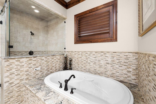 908 Watercliffe Dr, Lago Vista, TX 78645 - full bath featuring tile walls, a garden tub, tiled shower, and wainscoting