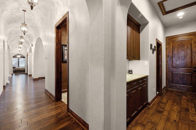 908 Watercliffe Dr, Lago Vista, TX 78645 - hallway with arched walkways and dark wood-style flooring