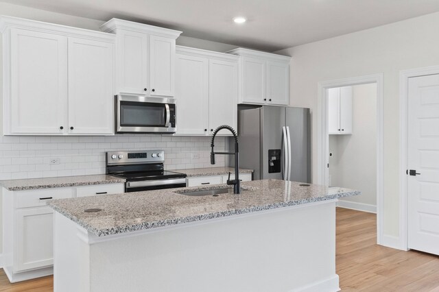 9509 Demure Dr Unit 4, Manor, TX 78653 - kitchen featuring stainless steel appliances, decorative backsplash, white cabinets, and recessed lighting
