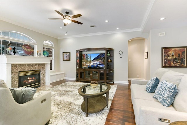 10309 Van Winkle Ct, Austin, TX 78739 - living area with arched walkways, a ceiling fan, dark wood-type flooring, ornamental molding, and a fireplace