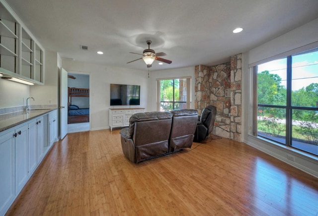 13111 Mansfield Dr, Austin, TX 78732 - living area featuring light wood-style flooring, ceiling fan, and recessed lighting