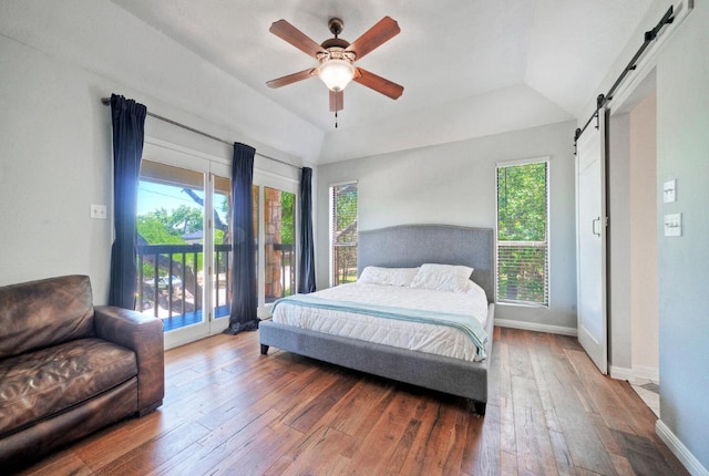13111 Mansfield Dr, Austin, TX 78732 - bedroom featuring a barn door, access to outside, multiple windows, hardwood / wood-style flooring, and vaulted ceiling