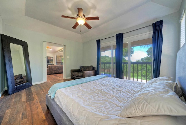 13111 Mansfield Dr, Austin, TX 78732 - bedroom with access to exterior, wood finished floors, a tray ceiling, and ceiling fan