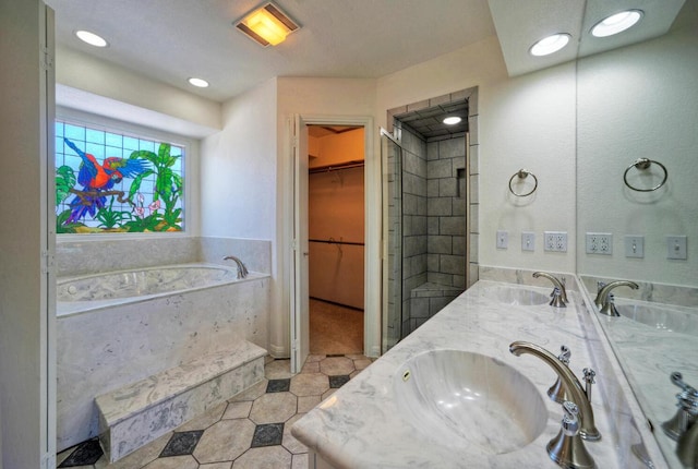 13111 Mansfield Dr, Austin, TX 78732 - bathroom with a bath, double vanity, a spacious closet, tile patterned floors, and a tile shower