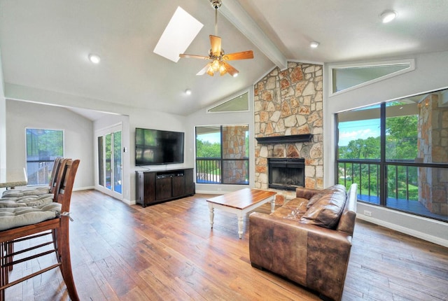 13111 Mansfield Dr, Austin, TX 78732 - living room featuring wood-type flooring, a stone fireplace, and ceiling fan