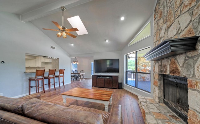 13111 Mansfield Dr, Austin, TX 78732 - living area featuring a fireplace, high vaulted ceiling, wood-type flooring, beamed ceiling, and ceiling fan