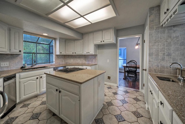 13111 Mansfield Dr, Austin, TX 78732 - kitchen featuring backsplash, cooktop, light stone countertops, and white cabinets