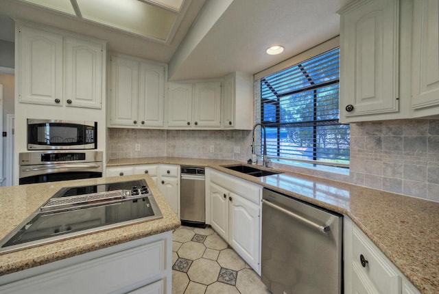13111 Mansfield Dr, Austin, TX 78732 - kitchen featuring stainless steel appliances, white cabinets, backsplash, and recessed lighting