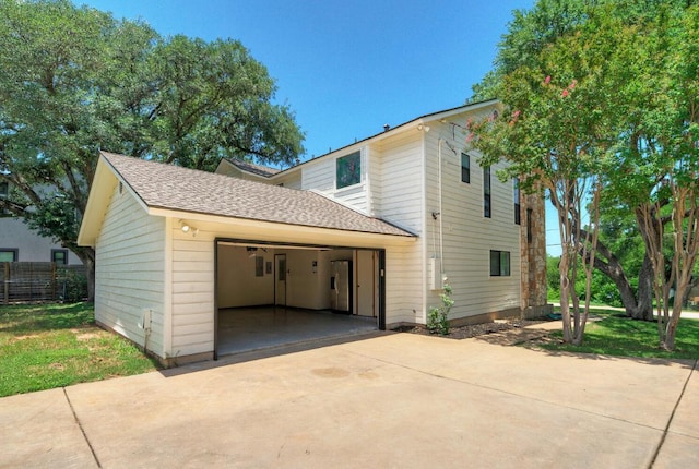 13111 Mansfield Dr, Austin, TX 78732 - view of home's exterior featuring a garage and roof with shingles