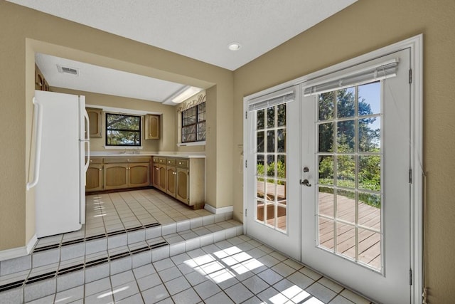 642 Lakebreeze Dr, Canyon Lake, TX 78133 - entryway featuring light tile patterned floors, french doors, and plenty of natural light