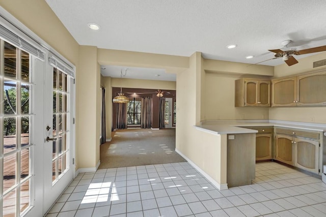 642 Lakebreeze Dr, Canyon Lake, TX 78133 - kitchen featuring ceiling fan, light countertops, healthy amount of natural light, french doors, and a textured ceiling