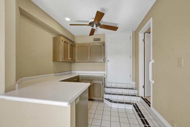 642 Lakebreeze Dr, Canyon Lake, TX 78133 - kitchen with a peninsula, light countertops, ceiling fan, and light tile patterned floors