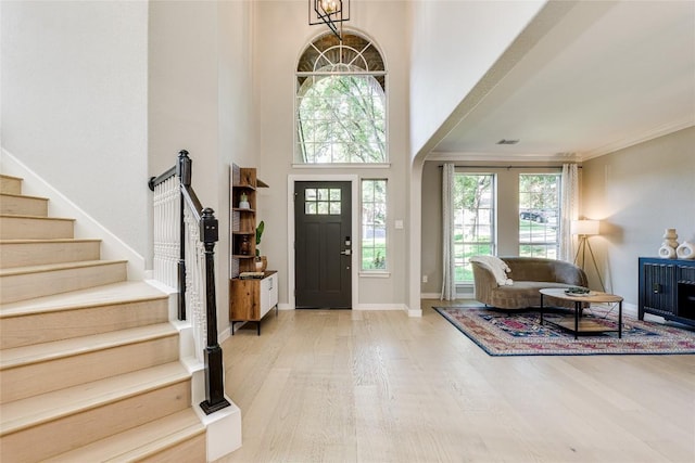 4105 Canyon Glen Cir, Austin, TX 78732 - foyer entrance featuring wood finished floors, stairway, healthy amount of natural light, a towering ceiling, and ornamental molding