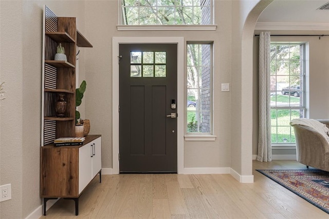 4105 Canyon Glen Cir, Austin, TX 78732 - foyer featuring arched walkways, light wood-type flooring, and crown molding