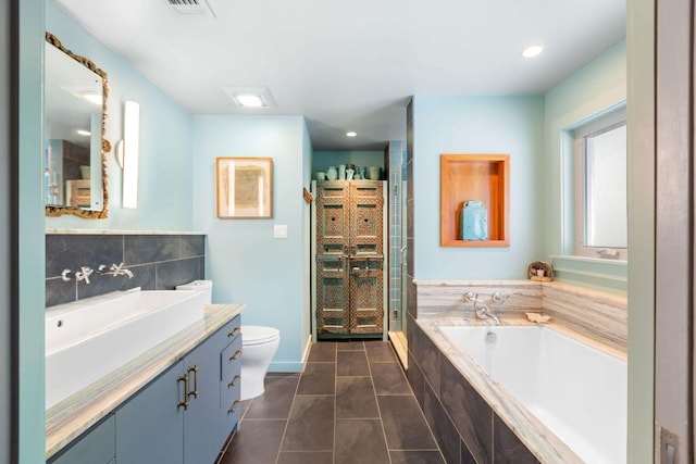 2606 Rockingham Dr, Austin, TX 78704 - full bathroom featuring vanity, a garden tub, a stall shower, tile patterned flooring, and recessed lighting