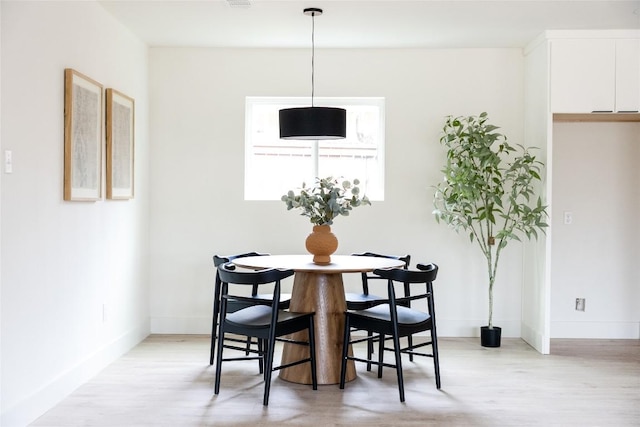 5731 Wellington Dr, Austin, TX 78723 - dining room featuring light wood-type flooring and baseboards