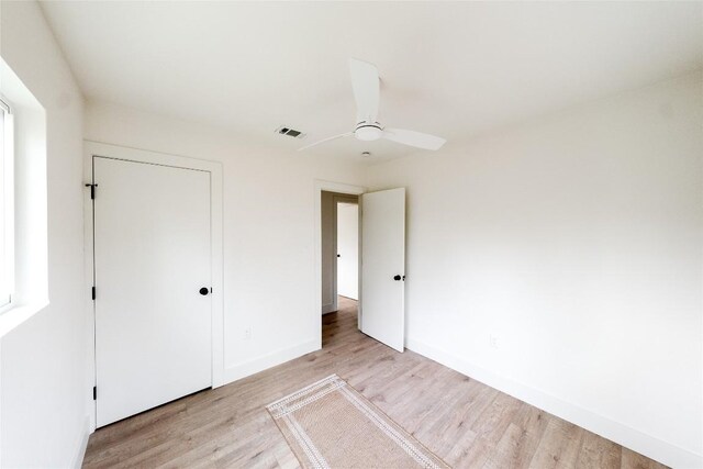 5731 Wellington Dr, Austin, TX 78723 - unfurnished bedroom featuring light wood-style floors, a closet, and a ceiling fan
