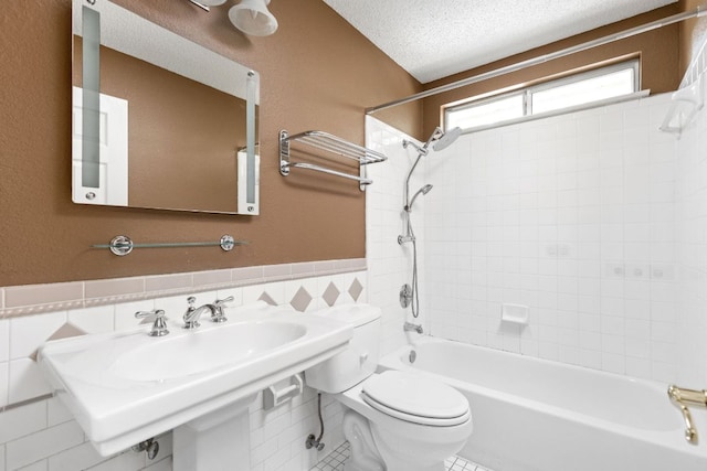 11978 Dorsett Rd, Austin, TX 78727 - bathroom with bathing tub / shower combination, tile walls, wainscoting, and a textured ceiling