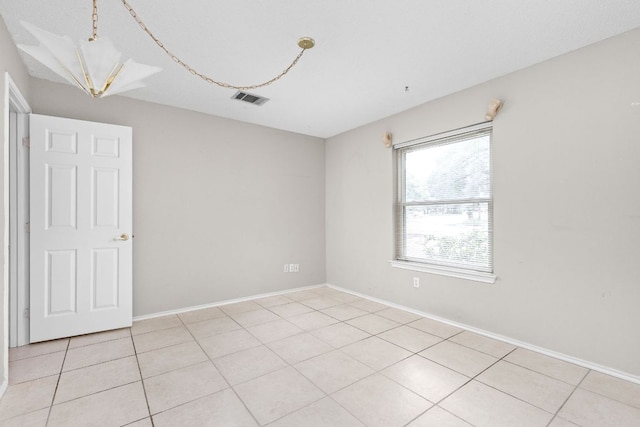 11978 Dorsett Rd, Austin, TX 78727 - spare room with light tile patterned flooring and a chandelier