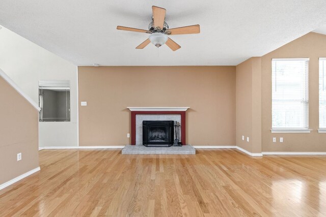11978 Dorsett Rd, Austin, TX 78727 - unfurnished living room featuring ceiling fan, light wood-type flooring, and a fireplace with raised hearth