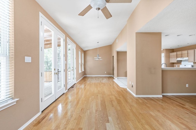 11978 Dorsett Rd, Austin, TX 78727 - foyer entrance featuring light wood-style flooring, a ceiling fan, a chandelier, and lofted ceiling