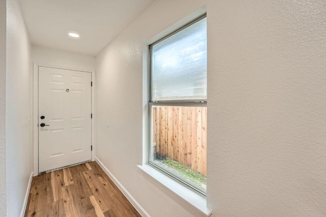 16825 Hamilton Point Cir, Manor, TX 78653 - doorway to outside featuring wood finished floors, plenty of natural light, and recessed lighting