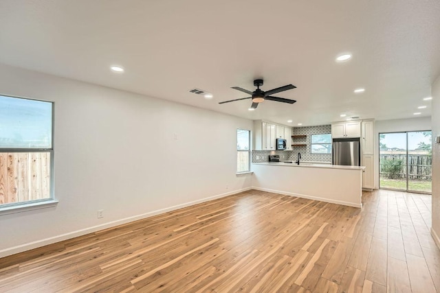 16825 Hamilton Point Cir, Manor, TX 78653 - unfurnished living room with light wood-type flooring, recessed lighting, and ceiling fan