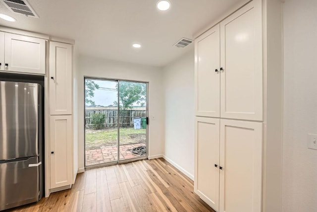 16825 Hamilton Point Cir, Manor, TX 78653 - kitchen featuring freestanding refrigerator, light wood finished floors, white cabinets, and recessed lighting