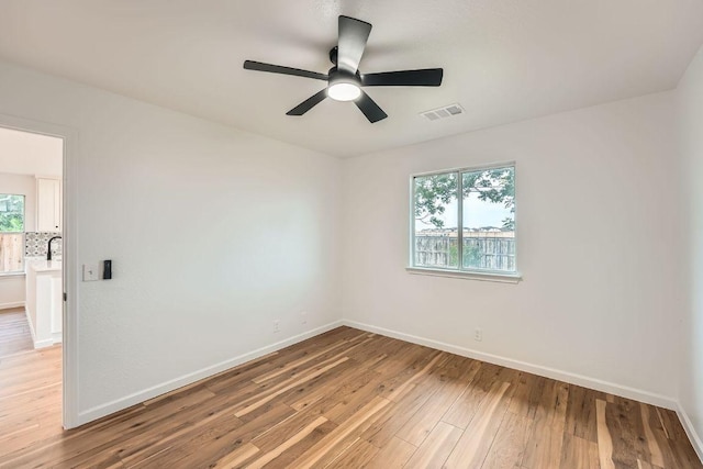 16825 Hamilton Point Cir, Manor, TX 78653 - unfurnished room featuring light wood finished floors, plenty of natural light, and ceiling fan