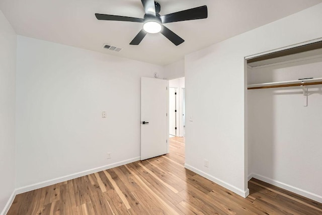 16825 Hamilton Point Cir, Manor, TX 78653 - unfurnished bedroom featuring wood finished floors, a closet, and ceiling fan