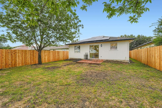 16825 Hamilton Point Cir, Manor, TX 78653 - rear view of property featuring a fenced backyard, roof mounted solar panels, and a patio