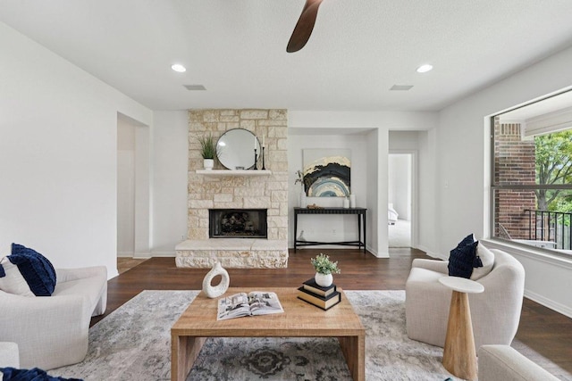 1508 Australis Cv, Austin, TX 78732 - living room with ceiling fan, a stone fireplace, wood finished floors, and recessed lighting