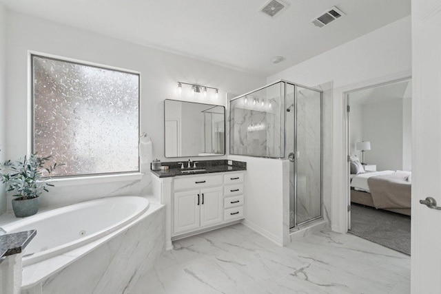 1508 Australis Cv, Austin, TX 78732 - full bathroom featuring marble look tile flooring, vanity, and a marble finish shower