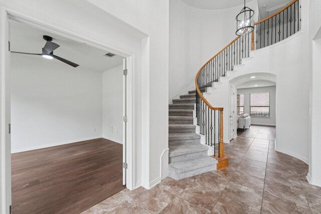 1508 Australis Cv, Austin, TX 78732 - foyer entrance with stairs, ceiling fan, a towering ceiling, and arched walkways