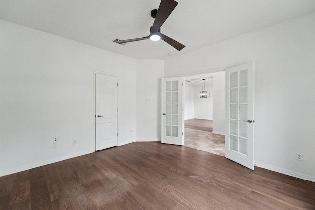 1508 Australis Cv, Austin, TX 78732 - spare room featuring french doors, wood finished floors, a ceiling fan, and a chandelier
