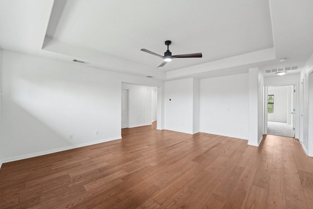 1508 Australis Cv, Austin, TX 78732 - unfurnished bedroom with a tray ceiling, wood finished floors, and ceiling fan