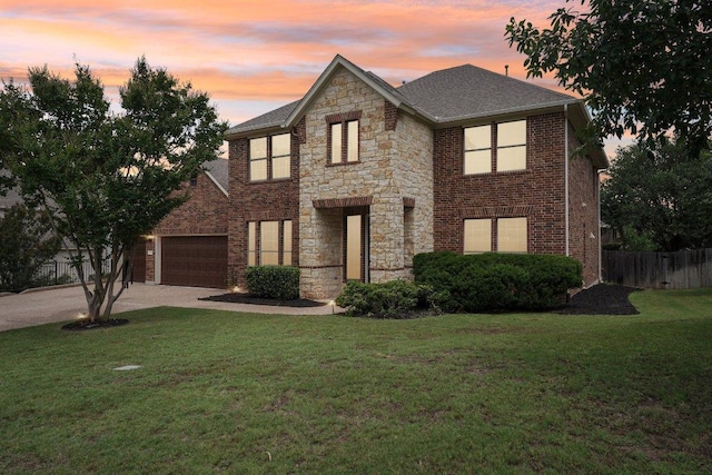 1508 Australis Cv, Austin, TX 78732 - view of front facade featuring driveway, brick siding, stone siding, a shingled roof, and a garage