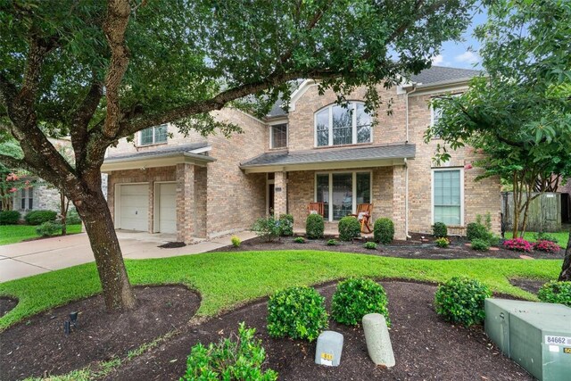 11404 Terrace Meadow Way, Manor, TX 78653 - traditional-style home featuring a garage, concrete driveway, a front lawn, and brick siding