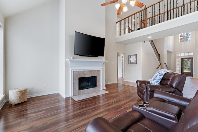 11404 Terrace Meadow Way, Manor, TX 78653 - living room with a towering ceiling, ceiling fan, a fireplace, wood finished floors, and stairs