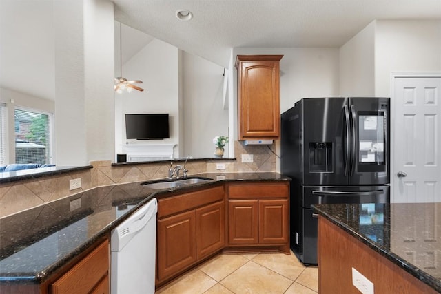 11404 Terrace Meadow Way, Manor, TX 78653 - kitchen with black fridge, white dishwasher, backsplash, and dark stone countertops