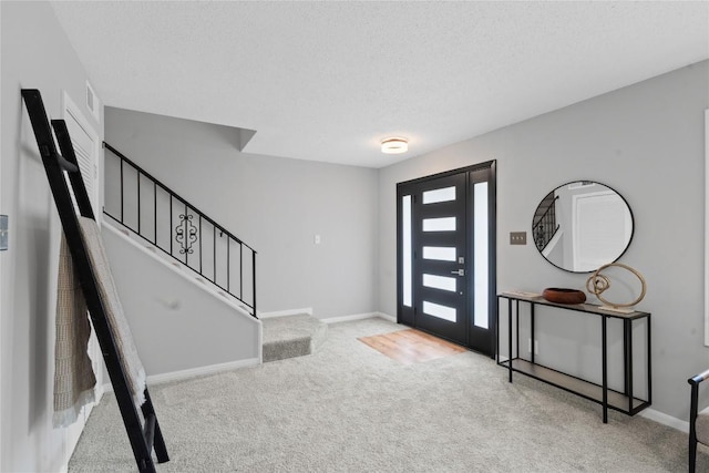 5317 Harvest Ln, Austin, TX 78745 - carpeted entryway with stairs and a textured ceiling