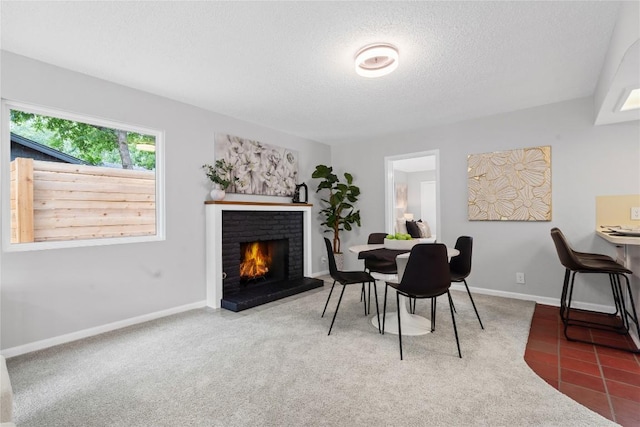 5317 Harvest Ln, Austin, TX 78745 - carpeted dining space with a textured ceiling and a brick fireplace