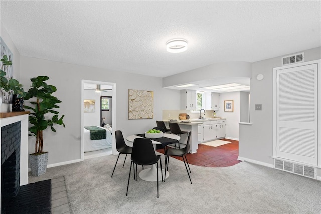 5317 Harvest Ln, Austin, TX 78745 - dining space with a fireplace, a textured ceiling, carpet flooring, and ceiling fan