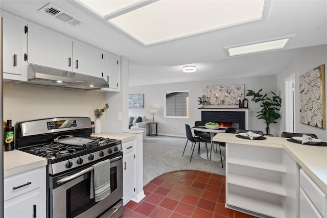 5317 Harvest Ln, Austin, TX 78745 - kitchen with stainless steel gas range oven, under cabinet range hood, open floor plan, and light countertops