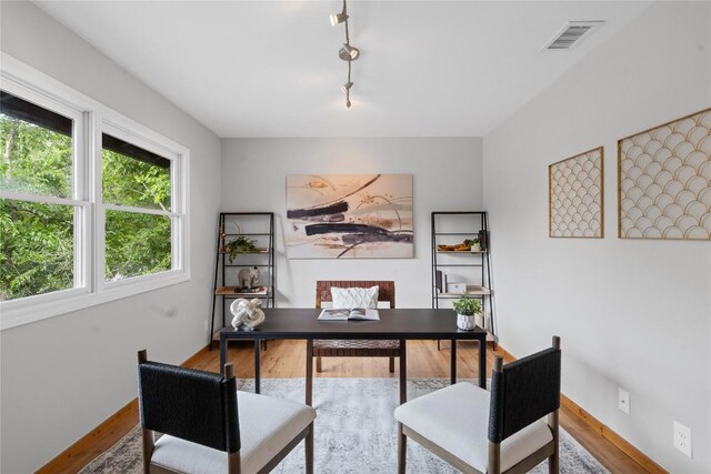 5317 Harvest Ln, Austin, TX 78745 - home office featuring wood finished floors and rail lighting